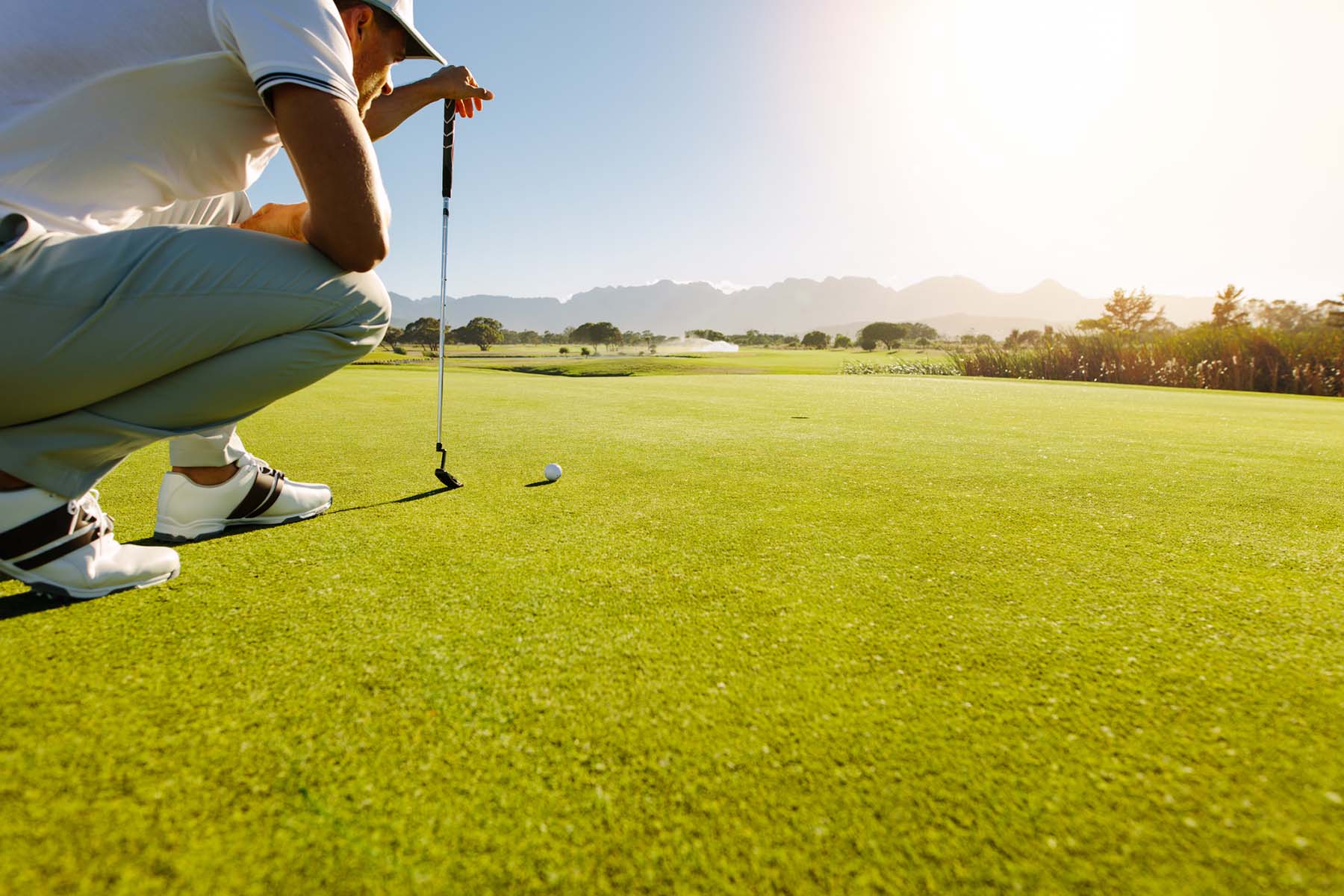 Man lining up golf putt highlighting values-based planning for purposeful retirement and lifestyle flexibility